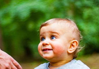 Portrait of a Baby Boy with Blue Eyes in park