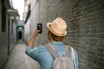 Young traveler taking pictures of the ancient city in asia style