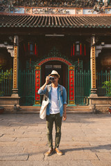 Young traveler taking pictures of the ancient city in asia style