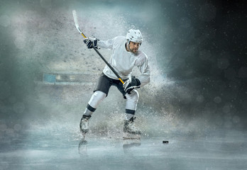 Naklejka premium Caucasian ice hockey Players in dynamic action in a professional
