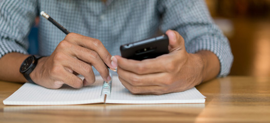 close up hand writing idea form smartphone device