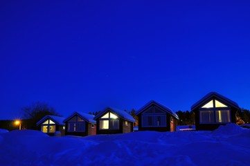 Cabins and snow at night