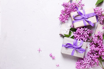 Wrapped  gift boxes with presents  and lilac flowers