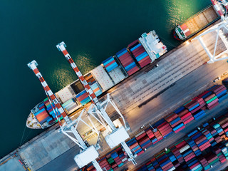Cargo container ship at the cargo international yard port and crane loading tank for export freight...
