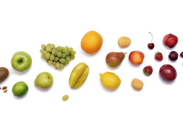 Rainbow colored fruit frame on a white table. Dieting, healthy food concept.