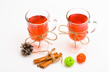 Hot drinks concept. Glasses with mulled wine or cider tied with twine string on white background. Mulled wine or hot beverage in glasses and cinnamon sticks. Traditional mulled wine with spices