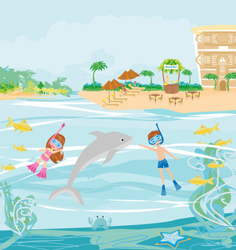girl and boy are diving with a dolphin