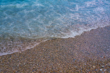 Natural sand beach with surf blue water on a background.