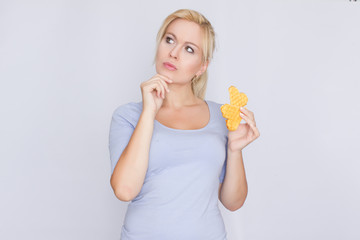 Happy blond woman holding in hands and showing belgian waffles