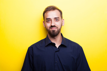 Happy joyful man smiling on yellow background in studio photo