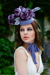 portrait of young sensual woman posing in elegant headwear