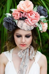 portrait of young sensual woman posing in elegant headwear