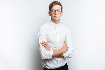 Portrait of young attractive guy in glasses, in white shirt, isolated on white background, for advertising, text insertion - obrazy, fototapety, plakaty