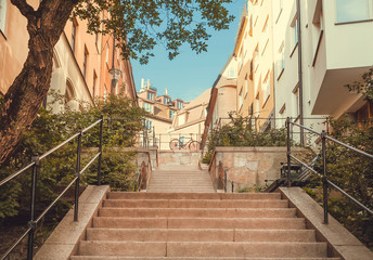 City bicycles and stairs between colorful historical houses in old area of Stockholm, Sweden.