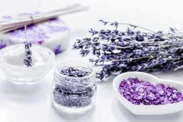 Obraz na płótnie Canvas organic cosmetic with lavender flowers and bath salt on white ba
