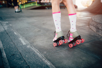 A picture of girl's legs in rollers. She is skating on the road. Also she is posing and standing on toes. © estradaanton