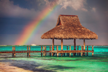 Rainbow over the Tropical beach in Punta Cana, Dominican Republic - obrazy, fototapety, plakaty
