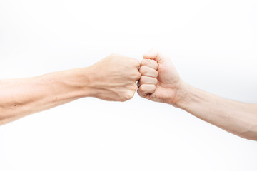 Close-up of the hand, makes a fist kick on a white background. Business people make a Cam pump together after a good deal. The concept of business success and teamwork.for advertisement