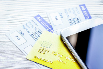 Credit cards with airline tickets for vacations on table backgro