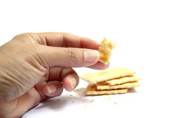 healthy adult hand hold a cracker on white background isolated
