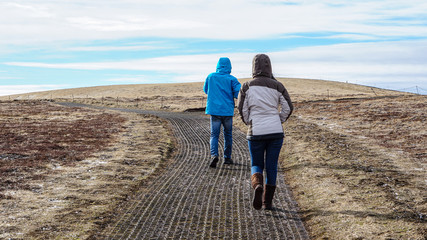 Tourists walk to fjord, Iceland pennisula bay