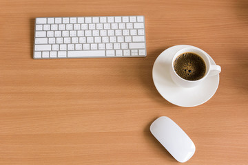 Keyboard computer,  Mouse computer and coffee cup on wooden table, Top view