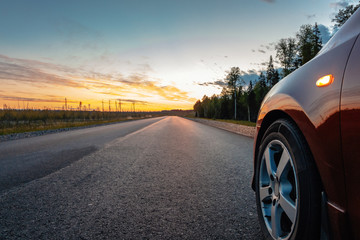 Cars on the road. Sunset in the countryside