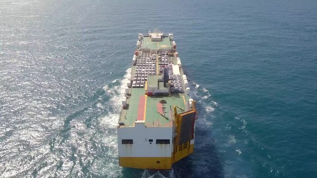 Aerial footage of a Large RoRo (Roll on/off) Vehicle carrier vessel cruising the Mediterranean sea.