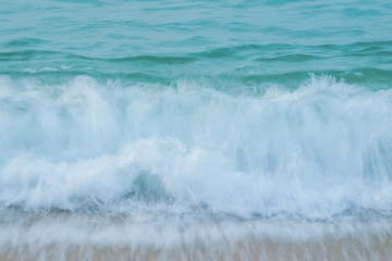 Movement of Soft Blue Ocean beach wave of the sea on the sand
