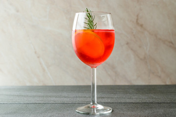 Aperol Spritz Cocktail with Orange Slice, Rosemary and Ice.