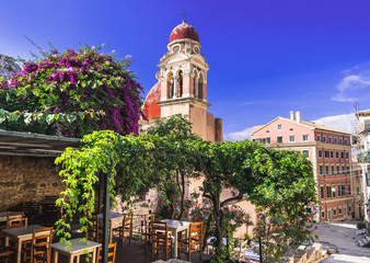 Corfu town picturesque street with cafe and flowers, Corfu island, Ionian islands, Greece