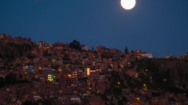 Moon rises over the city of La Paz. Bolivia. Timelapse at twilight.