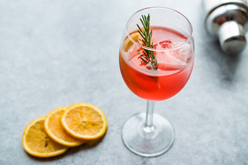 Aperol Spritz Cocktail with Orange Slice, Rosemary and Ice.