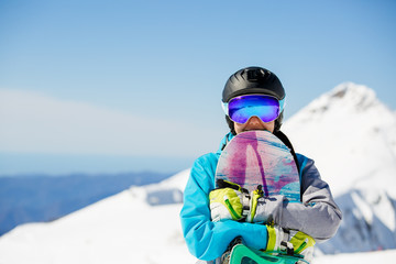 Fototapeta na wymiar Photo of athlete in helmet with snowboard on snowy hill