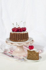 Homemade cake made from tea earl grey, with sugar icing. Decorated with cherries.