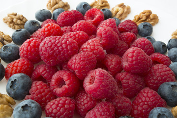 raspberry and blueberries on white background