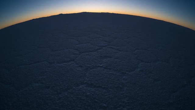 Salar de Uyuni at sunrise. Zoom in timalapse of the salt flat of Salar de Uyuni during sunrise, Bolivia.