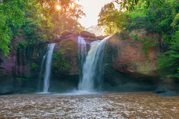 Fototapeta na wymiar Beautiful waterfall with sunlight in jungle, Haew Suwat Waterfall.