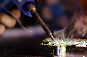 Repairing electrical appliances by soldering electronic circuits.