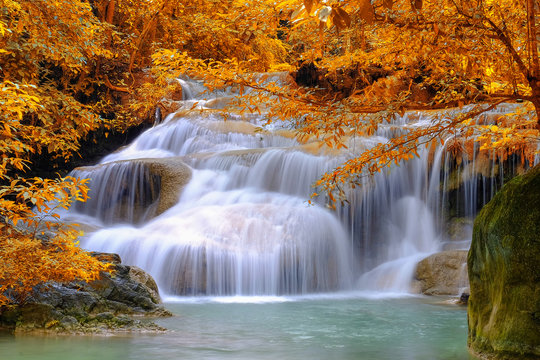 Beautiful water flowing in waterfalls in autume forest in Thailand.