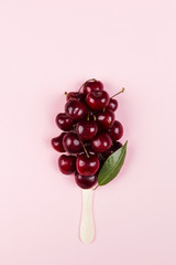 Ripe cherry in form of ice cream popsicles on a pink background. Top view. Food background