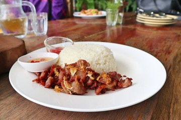 Fried pork with garlic topped with rice