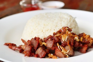 Fried pork with garlic topped with rice