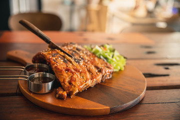 Roasted sliced barbecue pork ribs, focus on sliced meat. Delicious barbecued ribs seasoned with a...