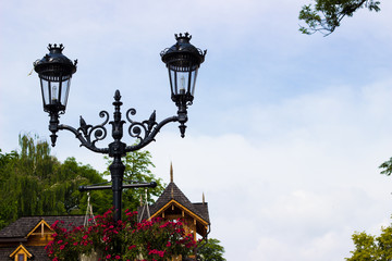Fototapeta na wymiar Vintage metal street lamp and blue sky
