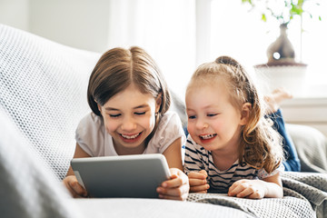 children are playing with tablet
