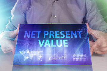 The concept of business, technology, the Internet and the network. A young entrepreneur working on a virtual screen of the future and sees the inscription: Net present value