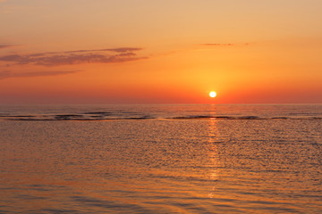 Obraz premium Baltic sea - early morning golden shades sunrise over the sea, panorama. Panoramic view. Kurzeme, Latvia