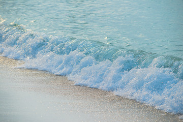 Fototapeta na wymiar Movement of Soft Blue Ocean beach wave of the sea on the sand