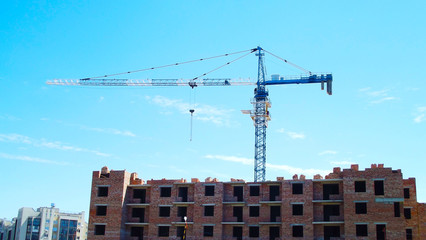 Fototapeta na wymiar Construction site.Crane on the background of the blue sky.